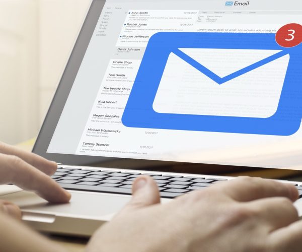 online business concept: man using a laptop with mail on the screen. Screen graphics are made up.